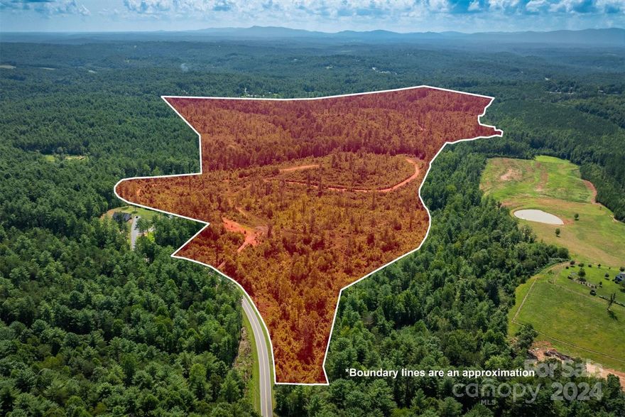 Discover the vast potential of this remarkable 184.372-acre property located in the scenic foothills of Western North Carolina. Zoned for residential use, this expansive tract offers an ideal opportunity for development or a private retreat. The land was timbered in 2022, leaving a network of logging roads. A tributary of Canoe Creek runs through a portion of the land. There is a possibility of a flood zone, it is not currently reflected on the official flood maps. Property has a scenic overlay, ensuring that any future development will maintain the area's natural charm and aesthetic appeal. Present Use Program offers tax benefits. Survey from 2019 available. Deed Restrictions. Closest public waterline runs along Highway 126. Whether you're looking to create a residential community or seeking a secluded haven surrounded by nature, this property offers endless possibilities. Don't miss this rare opportunity to own a piece of North Carolina's pristine landscape.