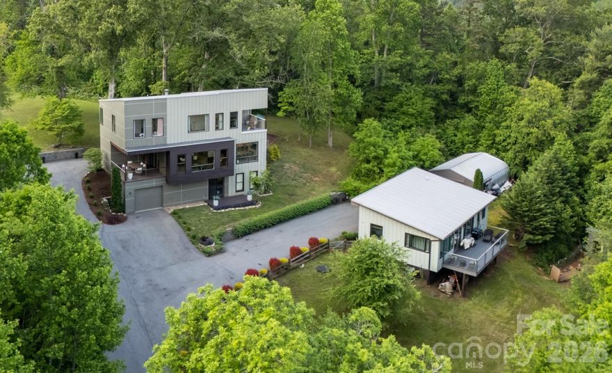 Stunning, two individual homes with a detached shop. 21 Wild Pine features easy flowing layout with an abundance of natural light illuminating neutral tones of the interior. Tastefully designed with quality in mind. This home offers many other rooms that could be utilized as an office, gym, or theater. Get inspired by the peaceful setting of this location and turn one of the rooms into an art studio! Invite your visitors from the guest house for a sauna night! Or live in the main house and rent/STR the guest house. Storage is plentiful as in addition to the attached garage, this property also features an on slab 25x42 garage with its own electrical meter. The coziness of 13 Wild Pine will make you feel right at home with a thoughtful layout to maximize space. This two bedroom guest house definetly feels bigger for its size. The options are endless in use and income producing options!