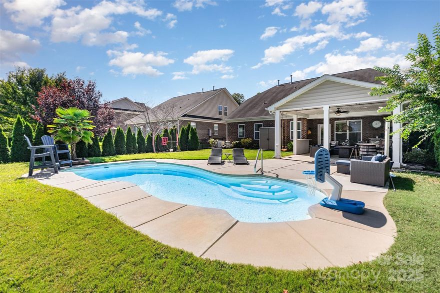 Entertainer’s dream in award-winning Clover schools! This full-brick 4-bedroom, 3-bath home lives easy with the Primary suite on the main level plus a second main-level bedroom with its own full bath—ideal for guests, an office, or multigenerational living. Second level boasts two additional bedrooms, a full bath, and a spacious family room m for play, workouts, relaxing or media. Smart-home upgrades include Alexa-linked dual-zone thermostats, Ring doorbell, and front and rear security spotlights. Fresh updated lighting, fans, and interior paint deliver a crisp, move-in-ready feel. Outside, your private oasis awaits: a 14,000-gallon heated saltwater pool, plus a built-in grill area, beverage cooler, and TV under the extended covered 464 square foot patio built in 2022—perfect for game day or summer nights. The flat, fenced yard is wrapped in privacy trees and enhanced by dusk-to-dawn landscape lighting. All of this in the heart of Clover—minutes to the lake and parks, about 30 minutes to Charlotte Douglas International Airport, with low South Carolina taxes. Come home to resort-style living, everyday.