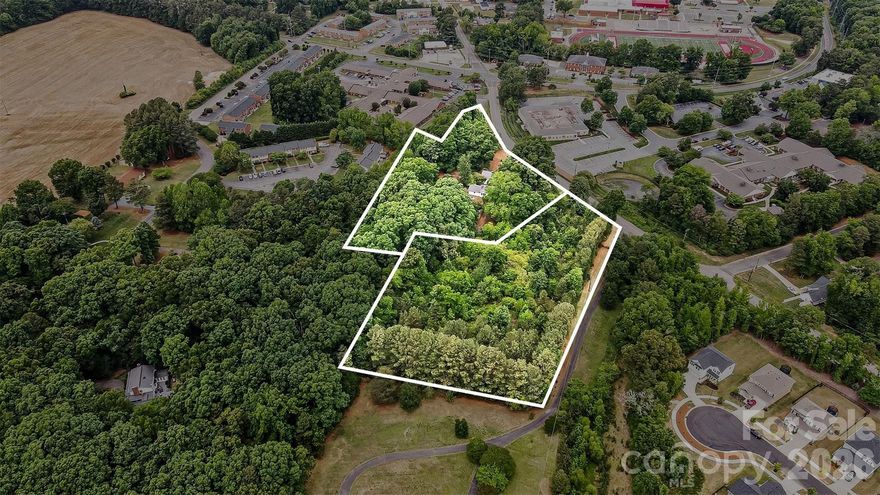 Prime development opportunity in the heart of Monroe! This expansive ±5.10-acre site, comprised of two contiguous parcels, offers a unique high-yield residential pivot. Zoned RLD (Residential Low Density) within the City of Monroe jurisdiction, the property is ideally positioned for a boutique residential cluster subdivision with a potential yield of 10-14 lots. Unlike many rural tracts, this site benefits from superior access to city water and sewer services.

The property features a charming 3,218 sq. ft. home built in 1920, which can be reimagined as a central clubhouse, HOA amenity center, or administrative office to anchor your new development. Alternatively, the site is well-suited for institutional uses such as assisted living, daycare, or private educational facilities via a Special Use Permit (SUP) through the Board of Adjustment.

With two manageable parcels (2.69 and 2.41 acres), investors can explore phased development or immediate resale of one half. Take advantage of this rare find in the Sunset/Franklin neighborhood where large, developable acreage within city limits is a finite resource. Don’t miss the chance to bring modern infill density to a location that maintains its distinct neighborhood character.