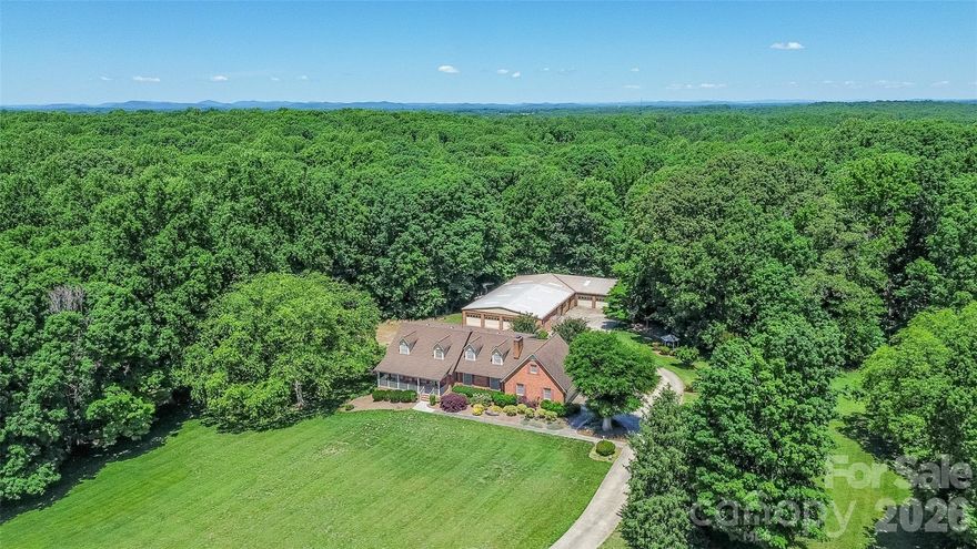 One-of-a-kind opportunity for the car enthusiast, hobbyist, collector, or business owner! Situated on 6.5 acres surrounded by beautiful farmland, this quality-built custom home offers the perfect blend of comfortable living and unmatched shop space. The true showstopper is the impressive 5,500+ sq ft heated and cooled auto shop featuring 8 bays, metal roof, paint booth, & lift, an incredibly rare setup with endless possibilities for automotive work, restoration, storage, or hobbies. The custom-built home offers 4 bedrooms and 2.5 bathrooms with generously sized rooms throughout and quality construction that provides excellent bones, while ready for cosmetic updates to match your style. The main family room showcases a gas fireplace with built-in shelving, while the sunken formal living room flows seamlessly into the formal dining area, creating inviting spaces for entertaining. The kitchen offers abundant cabinet and counter space, breakfast area, and built-in desk space. All 4 bedrooms are located upstairs and feature spacious layouts with large closets, including walk-in attic access through one bedroom closet for additional storage. Enclosed glass porch, paver patio with pergola for relaxing. Whether you’re searching for a private country retreat, a property tailored for your automotive passion, or a unique setup with exceptional shop capabilities, this property is truly a must-see.