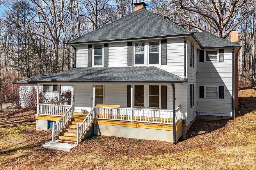 The quintessential farmhouse awaits! Enjoy the spring weather, front-porch rocking on the wraparound porch! This recently updated 4 Bed 2 bath home is the mountain oasis you've been looking for. Situated on 2.93 acres of unrestricted, level land only minutes to Asheville! Step in through the front door to an open floor plan concept with a grand exposed brick fireplace. Original hardwood floors will lead you into the primary suite on main with barn door accents and a private sitting area. Upstairs you will find 3 bedrooms, a full bath, and a kitchenette- perfect for 2nd living quarters! A new roof with 40 year shingles and new gutters were added in 2020. New septic in 2023! Feel like you stepped back in time as you enjoy the peaceful meadow!