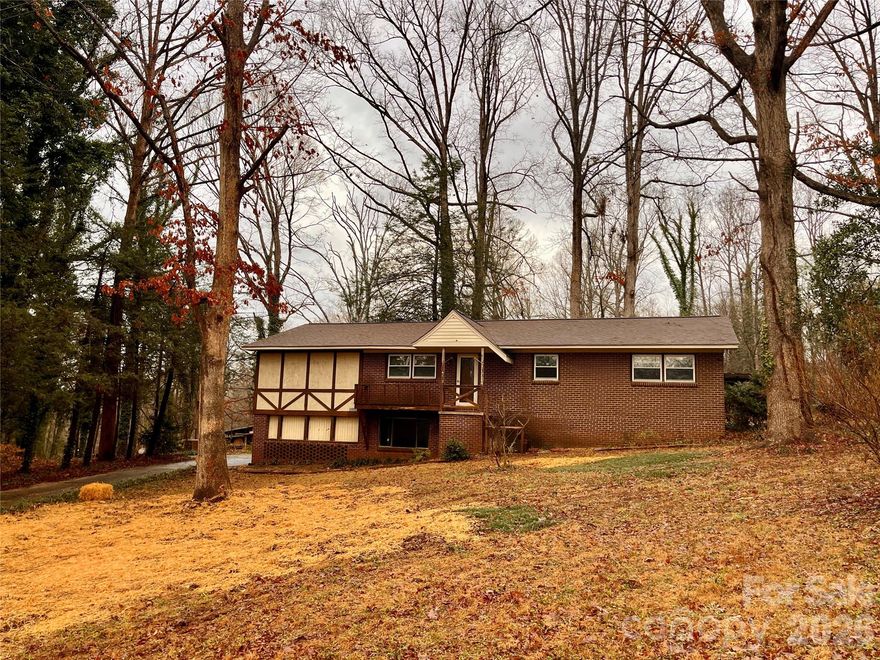 Looking for a new home that's AWAY but not too far from town?  Look no further.  Come at your touch to this unique home on almost 1 and 1/2 acres.  Large kitchen and HUGE Den!  Nice fireplace.   Screened porch and big backyard.  Workshop for someone who likes to tinker or maybe do some woodworking.  Welcome home!