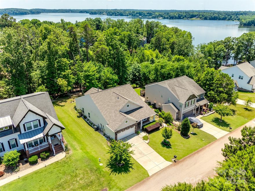 Resort style living awaits you at this well maintained home, w/ over $90k in upgrades post building! Enjoy the wooded backyard from the glass enclosed porch that slides to convert to a screen porch. As you head through the flat backyard into a paver patio area for the perfect fire pit spot, & enjoy the privacy of your lush yard. The rocking chair front porch greets you, & you will love the split bedroom floor plan. The great room boasts a stacked stone fireplace, & expansive island & butler's pantry provides tons of space. Both baths have granite counters, & the walk-in primary shower w/ bench is sure to impress. Custom primary closet, owned solar panels which provide almost all the electricity, are just a few features added (check out the attachments for more)! Edgewater is a destination community w/ amenities galore, incl golf, lake launch, sport courts, clubhouse, community activities, & the list goes on! W/ Charlotte & Rock Hill at your fingertips, & low SC taxes, Welcome Home!