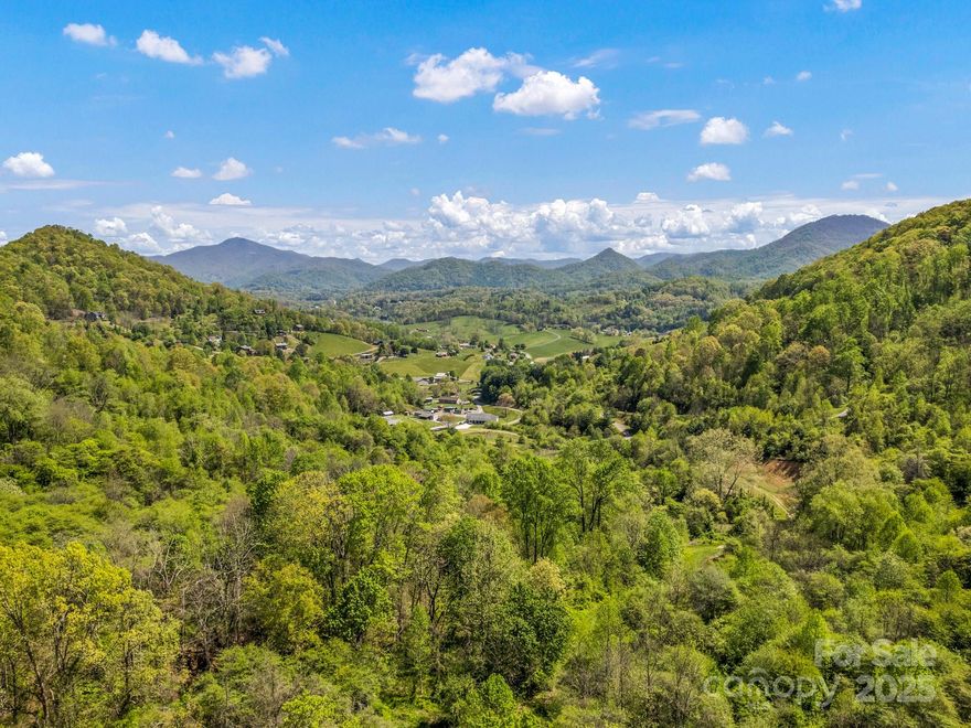 The opportunity to own large tracts like this in WNC is becoming increasingly rare and the amphitheater-like geography of this 193.6-acre property in Haywood County makes it incredibly unique. The heart of the property is gently rolling former pastureland that is surrounded by 180-degrees of ridge lines that provide fortress like solitude and long range views. A pristine stream runs through the center and a braided network of game trails and service roads roam the property. This is an ideal location for a generational home/farmstead, thoughtful subdivision, rental retreat, agritourism farm, Christmas tree farm, hunting lodge or 4x4/Mtn bike basecamp! There are multiple access points to city water and ready access to sewer and power nearby. End of road privacy and ultra convenient location with the entrance gate located only 2 minutes from exit 24 on I-40, 10 minutes to Waynesville and Canton and only 30 minutes to the Great Smoky Mountains National Park, Asheville and AVL Airport!