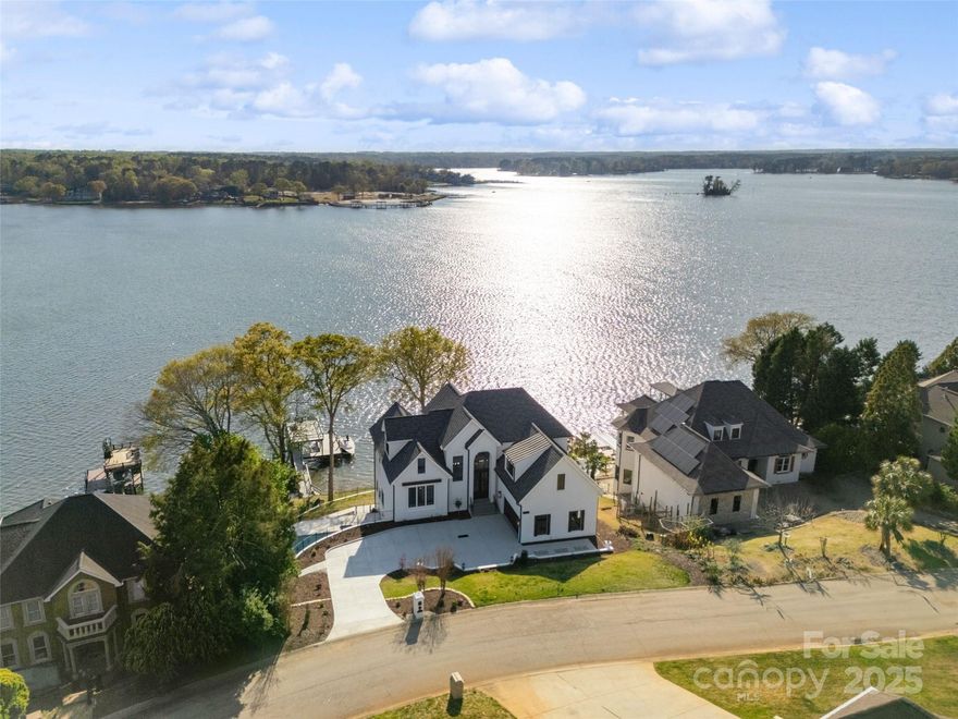 Stunning Main Channel Waterfront Home on Lake Wylie.
 
Discover luxury lakefront living at its finest in this exquisite waterfront retreat. Offering breathtaking views from almost every room, this exceptional home is designed for both relaxation and entertaining. Outdoor living is unparalleled with a private pool, a two-story dock and boat lift, and expansive lake views. Whether you’re enjoying a sunset from the dock or entertaining guests on one of the covered patios with custom cedar ceilings, this home is a true waterfront paradise.
Step inside to find gorgeous hardwood floors throughout. The chef’s kitchen is a dream, featuring full custom cabinetry, premium Viking appliances including a dual built-in refrigerator/freezer, & spacious butler’s pantry.
With two primary suites, the home provides ultimate comfort and luxury. Additional features include a sauna, wine cellar, roof with lifetime warranty, two laundry rooms, Restoration Hardware vanities and lighting, and so much more!