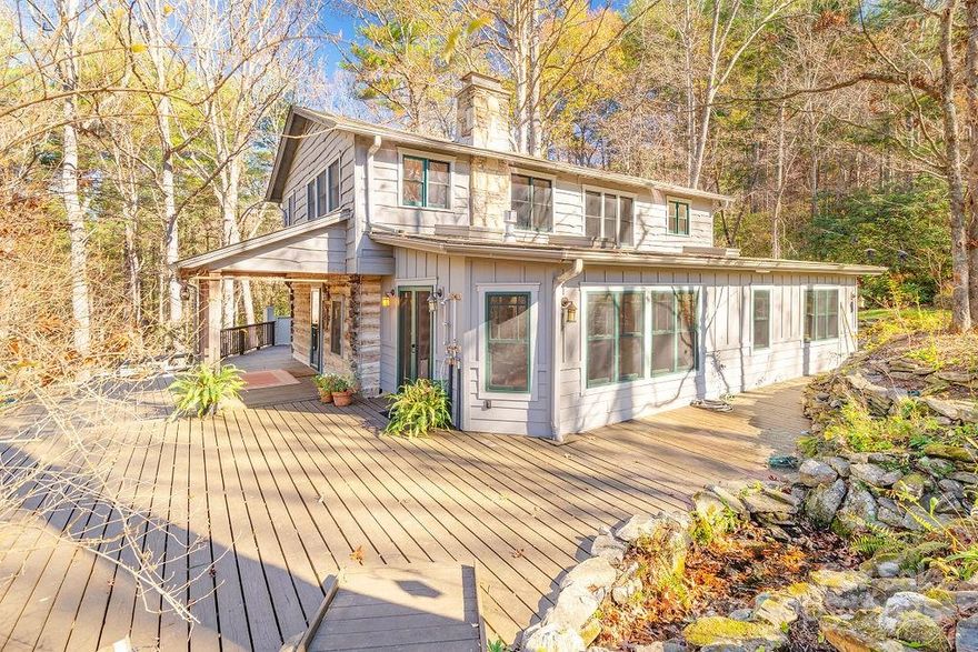 A true paradise for horse and nature lovers! This serene 8.17-acre property offers privacy, peace, and endless possibilities. Perfect for horses, livestock, farming, gardening, a flower farm—or simply a private retreat. The cozy living room, originally an 1800s chestnut oak cabin, features a woodstove and combines rustic charm with modern comfort. It opens into a spacious eat-in kitchen, ideal for gatherings. A bright and inviting sunroom overlooks wildflower gardens and a soothing waterfall. Upstairs, you’ll find a full bath, a primary bedroom, and three additional bedrooms. Unique architectural touches include recycled Douglas fir beams. Radiant floor heat in the downstairs bathroom and laundry room. Enjoy outdoor living on the expansive front porch and wrap-around deck, or relax in the fully fenced yard—perfect for pets. A registered Monarch Waystation and part of the Butterfly Highway, this home is a haven for pollinators and nature watchers alike. Just 20 minutes from Asheville and close to local breweries, hiking trails, and more.