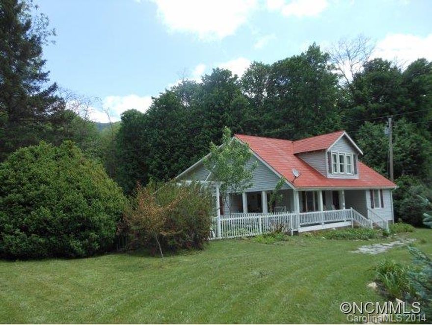 Charming 1920's old, converted School House. Now a 1 1/2 Story, 2,046 Sqft, 3 Bedroom/1 Bath Farmhouse, plus a bonus rm/bdrm & a loft, where active creeks converge at the Upper Fines Creek headwaters. Original solid wood floors, red metal roof,vegetable & flower gardens, plus mountain views. Easy access from state maintained road. Relax on your covered porch, and savor views & a home, where time has stood still!  Some Furnishings Negotiable!