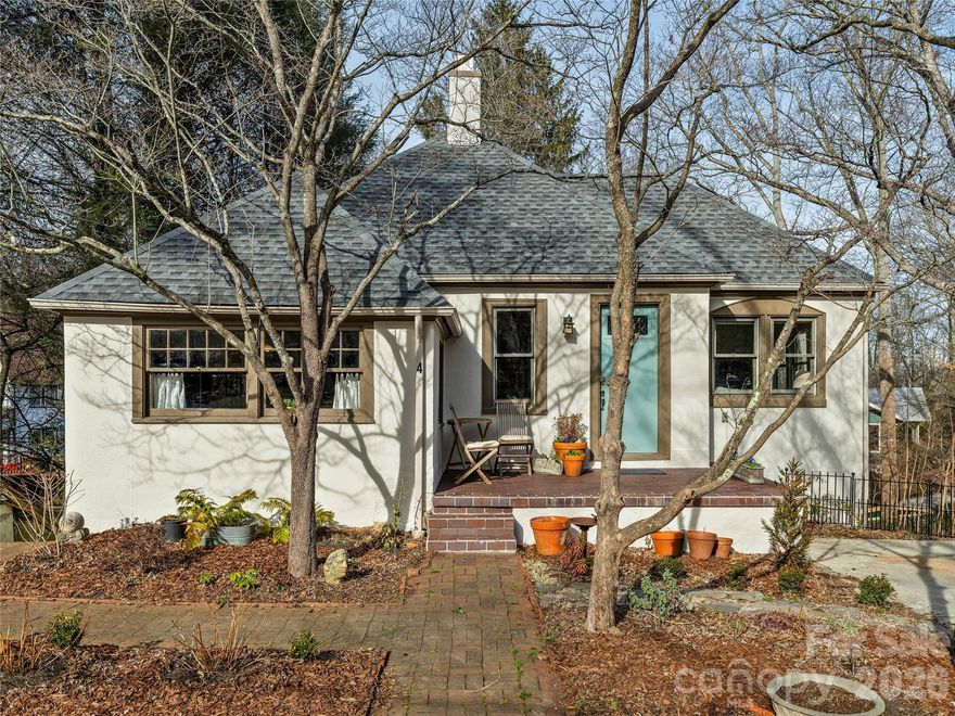 Beautiful Historic Kenilworth 1927 Tudor! Located in a quiet location in this desirable neighborhood — known for its tree-lined streets, sidewalks, and proximity to parks, hospitals, and vibrant local dining — this home has classic curb appeal with a thoughtfully planned perennial garden to greet you. This home offers inviting, light-filled spaces. The main level of the home has a bright living room with an open dining area. The new spacious kitchen and Primary Suite on Main were created by the current owners to fit the classic aesthetic of the property. The kitchen has classic character with custom cabinetry features including a Stand-Mixer lift and cleverly concealed Laundry. Quartzite countertops and a center island provide ample workspace and storage. Newer high-end stainless steel appliances. An en-suite primary bedroom and full guest bath are located on the main level. The 2 downstairs bedrooms are peaceful spaces with a shared half bath. One is currently used for a craft/sewing space but was the previous main kitchen so it is pre-plumbed and could be converted back to a kitchen or turned into a full bath. Outside on this level a comfortable covered deck overlooks the private fully-fenced yard with room to garden, play, or just relax and enjoy Asheville’s seasonal beauty! The unfinished basement area has a walk-out workshop or creative space, and plenty of storage. Fantastic location and move-in ready! This home has space and flexibility for the next caretakers. Create an In-Law Suite or small rental on the lower level for potential added equity. $2,500 seller credit at closing with accepted offer. This warm, inviting home is ready for its next caretakers!  3D Tour and Floor Plan:  https://youriguide.com/4_duke_st_asheville_nc/