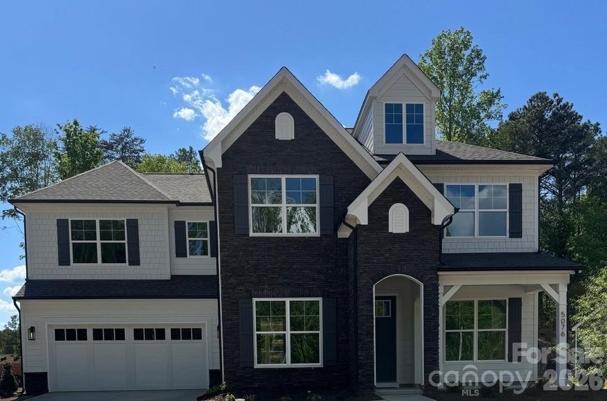 This Colfax plan features a guest suite on the main with an ensuite bath AND a secondary bedroom upstairs, also with an ensuite bath. The home has 5 bedrooms, 4.5 baths, a sunroom and more than 3,600 square feet of living space. The main floor also features a designer kitchen with a butler pantry, family room with Cosmo fireplace and shiplap surround, powder room, dining room with tray ceiling, and an office with French doors and a faux coffered ceiling. The kitchen features white cabinets, quartz counters, a tile backsplash, and stainless appliances, including a gas cooktop, range hood, and wall oven. The upper floor has 9-foot ceilings & includes the loft, primary suite, three secondary bedrooms, two full baths, and the laundry room with storage cabinets. Other extras include quartz counters in all baths, metal balusters, and Enhanced Vinyl Plank flooring. This home has it all and more! Visit today!