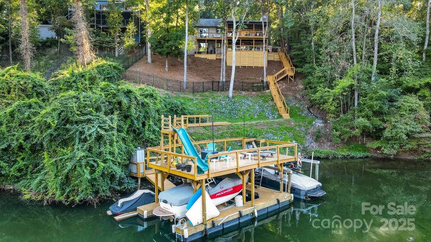 Charming, fully remodeled waterfront home nestled in a tranquil cove moments from Lake Wylie's main channel. This exceptional property feels like a serene retreat that has been updated from top to bottom! It includes a 2-story private floating dock in deep water, 2 boat lifts, a slide & sundeck. Step inside to discover a bright, open floor plan adorned w/ LVP floors & upscale finishes. The kitchen is a stunning focal point w/ a spacious island, marble backsplash, quartz countertops, and new stainless steel appliances. On this level, you’ll find the spacious primary suite with a walk-in closet and balcony, a 2ndry bedoorm & the laundry. Head down to a finished walk-out basement complete w/ rec room, 2 bedrooms, full bath, office & 2 large storage rooms for tools, bikes, and other equipment. Your living space is extended w/ a covered double-decker back porch offering unparalleled views overlooking the lake. Schedule a viewing today to experience the charm of lakeside living firsthand!