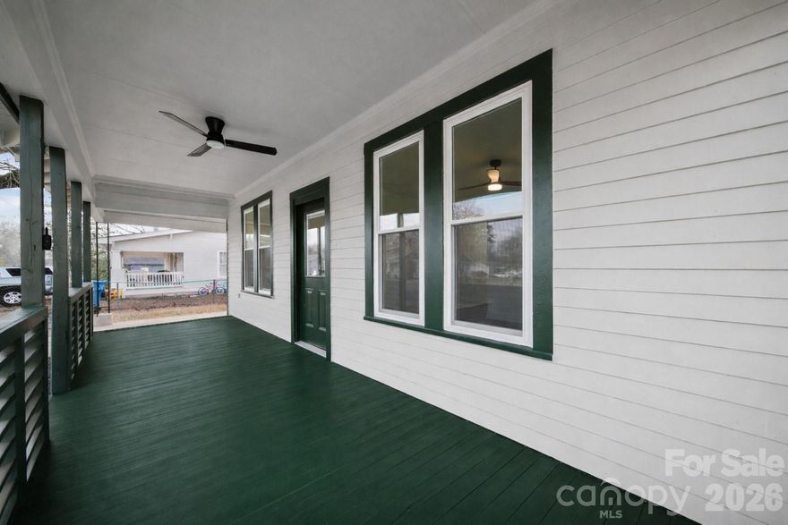 Expansive 27-foot covered front porch with ceiling fan, covered carport, and a beautifully remodeled 1932 home blending timeless character with modern living — outdoor living and covered parking you won't find at this price point in Albemarle.This charming 3-bedroom, 2-bath residence offers 1,403 square feet with Luxury Vinyl Plank flooring throughout, a beautiful original decorative fireplace anchoring the living room, and a rear deck — giving you covered outdoor living space on both the front and back of the home.

The stunning updated kitchen features granite countertops, new stainless steel appliances, new cabinetry, and a tile backsplash, opening to a large dining area that flexes easily as a second living space. Both bathrooms have been tastefully updated with tile floors, new vanities with quartz tops, and new lighting and fixtures throughout.A huge mudroom, laundry room, and pantry combination off the kitchen adds exceptional day-to-day functionality. A unique flex room off the dining area showcases original wood walls and works beautifully as a home office, study, music room, or extra storage.

Conveniently located near Stanly Community College, lakes, parks, and the vibrant Albemarle community — just minutes from downtown Albemarle and approximately one hour to Uptown Charlotte.Schedule your tour today and experience the perfect mix of charm, character, and outdoor living. Fireplace is decorative only.