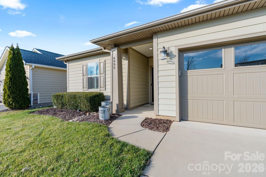 Beautifully maintained home featuring a highly sought-after Connect floor plan with an open-concept design.  Enjoy LVP & tile flooring throughout the main living areas and a stunning kitchen offering abundant storage and generous counter space, complete with a tiled backsplash, large center island, and a unique pantry door that adds character and a modern, resilient design.  Designer lighting enhances the home throughout. The primary bedroom showcases a custom barn door and a luxurious en-suite bath with a dual-sink vanity and a spacious walk-in closet with built-in custom shelving.  An office/den flex space features a wood & glass barn door accent, perfect for working from home or a creative retreat.  Two additional spacious guest bedrooms and a full bath provide comfort and privacy for visitors.  Plantation shutters are installed throughout the entire home. Step outside to a private lanai & an extended paver patio that backs up to serene greenery.  Ideal for entertaining!  Trilogy membership includes access to Freedom Boat Club on Lake Norman and award-winning resort-style amenities.