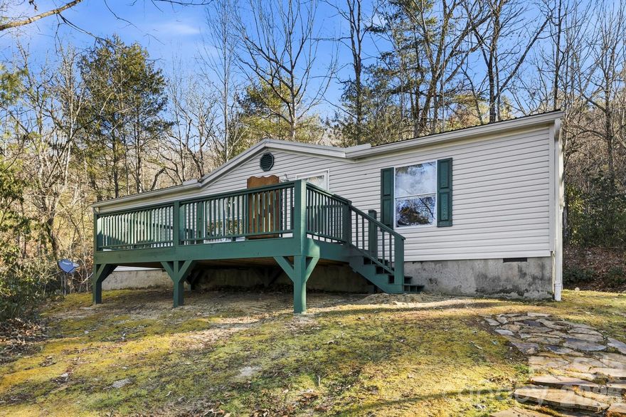 Set against the natural beauty of the mountains, 76 Gobblers Knob Road offers the perfect blend of space, privacy, and convenience. Situated on 2 peaceful acres, this 3-bedroom, 2-bath manufactured home feels like a true retreat while still keeping you close to everything that makes Western North Carolina special.

Inside, the split-bedroom layout gives everyone their own space, while the open-concept living area creates an easy, welcoming flow for everyday life. Step out onto the large front deck and imagine slow mornings with coffee, evenings unwinding in the fresh mountain air, or hosting friends for a casual get-together.

The land (+/- 2.091 acres) offers privacy, room to roam, and plenty of space to grow—whether that means adding on, creating a garden, or simply enjoying the location. Outdoor lovers will appreciate being just minutes from Pisgah National Forest and DuPont State Park, with downtown Brevard close by for local shops, restaurants, and community events. Etowah and downtown Hendersonville are also an easy drive, giving you the best of both small-town charm and everyday convenience.

If you’re looking for a place where you can slow down, spread out, and still stay connected, this home checks a lot of boxes.
