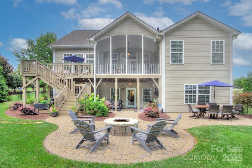 Welcome to the lake! This elegantly understated home on a tree-lined lot with water views will have you at hello! Don't let her fool you - this home is sprawling! From the open floor plan, primary on main, upstairs hideaway + finished basement, there is room for it all! Luxury finishes include quartz counter tops, custom closets, heavy molding and ceilings for days! Step outside to so many spaces to relax + play! Enjoy the game or a good book on the screened porch, take in the view from the deck or head down stairs to the paver patio with fire pit and even more room to grill and entertain! Perfectly manicured, fully fenced yard with irrigation. Resort style amenities with kayak + boat launch, pickleball court, two pools, dog park + boat & RV storage! Cruise in your golf cart and head to the pool or pop by a neighbor’s porch! Hop on the boat to all that Lake Wylie has to offer. Life on the lake starts now! Just minutes to the airport, Uptown, The Whitewater Center + downtown Belmont!