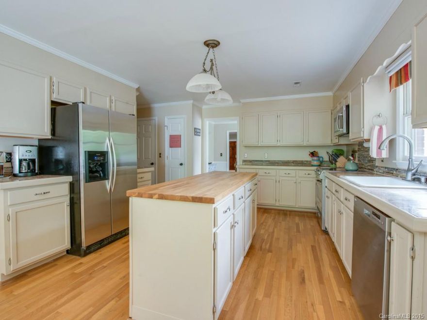 READY to ENTERTAIN? This gorgeous home is ideal for gatherings! Open flr plan provides grt flow. Welcoming entry is open to liv. rm. Kit w granite counters, butcher block isl, 2 pantries, cabinets galore- pic. window looks to vast 3 tiered deck.Tons of natural light. Mstr + 2 bed rms on main level. Generous rms & closets. Lower level is PHENOMINAL- flexible space can be rec rm/den, 4th bed (add door back), 2ND LIVING QTRS- full bath, kit sink, exterior door already there! HOME BREWERS DREAM!!