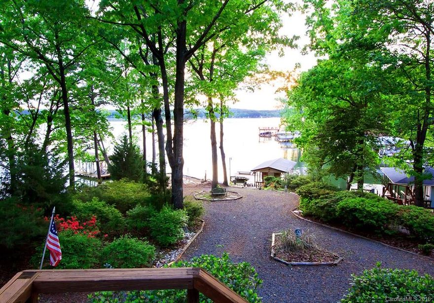 Big view into main channel, beautiful level lot. Sunroom on lakeside of house has a beautiful big lakeview. Top level used as owner's suite w/lake view. Unfinished basement is heated/cooled by heatpump & is currently used as workshop/fun space has garage door w/sliding screen that opens to a beautifully landscaped patio facing the lake. Boathouse has storage, lift & large deck for entertaining. New heatpump for main & basement. New energy efficient ductless heat/air up.Very well maintained home!