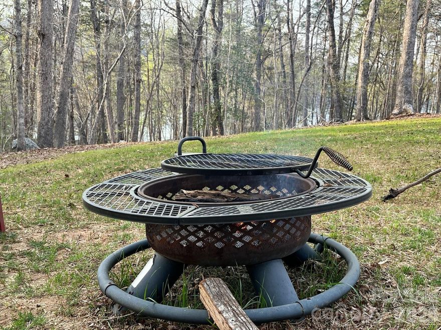 Attention nature lovers and outdoor adventurers!!Do you enjoy hunting, fishing, kayaking, hiking, boating and more? Then baby do I have one for you! This gorgeous, rustic, modern home with a true partial view of Lake Tillery is located in the beautiful lakefront, gated community of Carolina Forest in Montgomery County North Carolina and in the heart of the Uwharrie National Forest. Public hunting land is literally within walking distance. Enjoy access to Lake Tillery, gate security, a community pool, boatslips, a boat ramp and canoe launch, pickleball and basketball courts as well as hiking trails throughout the subdivision. Built in 2025 and gently loved on, this custom designed home has all the feels and is still under the one-year builder's warranty. Enjoy beautiful sunrises from the covered front porch and breathtaking sunsets over Lake Tillery and Morrow Mountain State Park from the large deck in back. The home has a whole house Generac generator with an owned propane tank which means no rental fees. The front of the home has real stone, mixtures of styles of vinyl siding, and the porch and shed dormer have a metal roof adding to the variety of textures, colors, value and curb appeal. Featuring an open floor plan with nine-foot ceilings throughout and ceilings that are vaulted and have faux beams in the great room and kitchen, a wood burning fireplace, and butcher block countertops in the kitchen, the extra touches are on display in this warm and inviting place! A large kitchen with plenty of cabinets and a massive island has everything you need including smart appliances and well thought out design. The large master suite has a luxury bath with a clawfoot tub and designer fixtures, large shower with a seat, and double barn door style vanity with double sinks and double mirrors. There is a private entrance from the deck into the master bath, and it has been pre-wired for a light and ceiling fan for a future porch. The master bedroom has a large walk-in closet and barn doors that add to the rustic feel of the home. There is LVP flooring throughout the entire home making clean up a breeze! The custom-made trim throughout the home is another extra touch present in this dream home. Little Rover will be safe in the small, fenced dog area in back while you enjoy the frequent deer that visit here in the Uwharrie National Forest, the bald eagles that fly overhead and many varieties of birds and waterfowl. There is never a dull moment here with fun on the lake and in the nearby recreational areas hunting, fishing, camping, drifting down the Uwharrie River and much more!! For our Bigfoot enthusiasts, there have been shows filmed in this area that claim sightings! Even Bigfoot loves the Uwharries!  This home has character, color, and was lovingly designed. You could be on Lake Tillery living the dream. Agent must accompany you to view