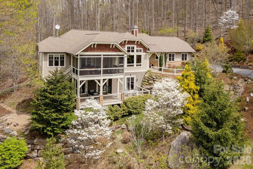 Nestled in the prestigious gated community of Somersby Park, this exceptional home offers the perfect blend of refined luxury, privacy, and breathtaking mountain living. Thoughtfully designed with impeccable attention to detail, this expansive residence showcases high-end finishes, timeless architecture, and an effortless flow ideal for both everyday living and elegant entertaining.
From the moment you enter, you’re greeted by soaring ceilings, abundant natural light, and stunning craftsmanship throughout. The gourmet chef’s kitchen is a true centerpiece, featuring custom cabinetry, beautiful granite countertops, a breakfast bar and a walk in pantry—opening seamlessly into a warm and inviting great room with a grand stone fireplace and expansive windows framing serene mountain views.
The main-level primary suite is a private retreat, complete with a spa-inspired bath, walk-in shower, and generous custom closet space. Three additional bedrooms and expansive living areas provide ample room for family and guests, while thoughtfully designed spaces such as a home office, hobby/exercise/flex area offer flexibility to suit your lifestyle. The lower level also offers high end features including a built in sauna, steam shower and convenient wet bar. A Generac natural gas generator was installed January 2025 for peace of mind. Screened porch and front deck furnishing will convey. 
Step outside to experience true mountain tranquility. Expansive decks and outdoor living spaces create the perfect setting for entertaining or simply enjoying the peaceful surroundings. Whether hosting gatherings or savoring quiet mornings, the setting is both private and picturesque.
Located within Somersby Park, residents enjoy a secure, gated environment with beautifully maintained grounds, scenic landscaping and a strong sense of community—all just minutes from shopping, dining, and amenities. This property is situated just below Jump Off Rock, arguably the most scenic point in Henderson County and just a short hike from this beautiful home.
This is more than a home—it’s a lifestyle of comfort, elegance, and natural beauty.