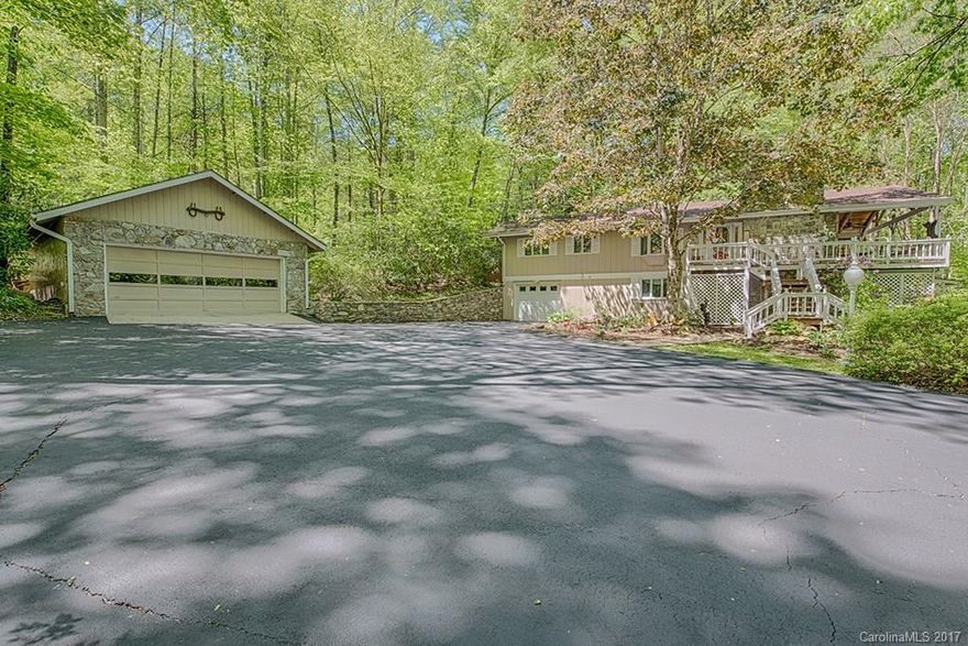 This home has everything! Lovingly cared for and updated 2 story home in Maggie Valley, with year round paved access. A wonderful family home on 1.42+/- level acres with bold creek and plenty of yard for family fun. This home offers all the space you would need for a large family or vacation home, would be a great vacation rental. Upper level has updated kitchen open to dining and great room with floor to ceiling stone fireplace a large master suite  walk in closet,guest en suite, laundry, 1/2BA