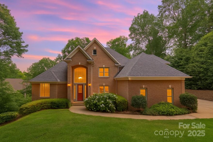 Elegant custom brick waterfront home with private dock & expansive living spaces to host guests year round with 2nd living quarters on finished walk-out basement level! Enjoy lakeside living year round in this 4+ BR retreat, beautifully set in a prime Mooresville location on a deep water cove. Quality built & designed for everyday comfort & effortless entertaining across three levels, the open floor plan features a main-level primary suite, formal dining room, a soaring great room with stacked-stone fireplace & custom built-ins. The kitchen features a center island with bar seating, breakfast room & all with access to beautiful maintenance-free porches offering privacy while relaxing lakeside. Upper level has 2 additional BR, full BA, & large bonus currently serving as home office. The basement level is ideal for extended guest stays, with 2 BR, 2 full baths, recreation/billiard areas, & 2 workshop spaces perfect for hobbyists with garage entry on lake level. Walk to community pool!