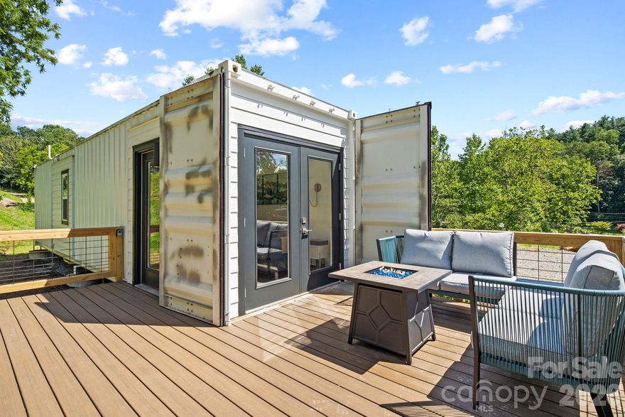 Own a rare modern container retreat just minutes from Asheville—with this  tiny home, Pearl (10) and Onyx (8), available individually ($299,000 each) or together ($595,000) for a unique lifestyle or investment opportunity.

Pearl Container Home offers a thoughtfully designed modern retreat that blends contemporary style with low-maintenance living. This stylish tiny home features a comfortable queen bedroom, a sleek and efficient kitchen with all the essentials, and a beautifully maintained full bath.

Outdoor living is a highlight, with a spacious main deck ideal for relaxing or entertaining, plus a private deck off the bedroom—perfect for morning coffee or evening stargazing. The intentional design and inviting atmosphere create a distinctive experience that appeals to both homeowners and short-term rental guests alike.

Pearl is one of two container homes available on separate parcels—Pearl and Onyx. Each property may be purchased individually or together, offering flexibility for buyers seeking a private mountain getaway, an income-producing short-term rental, or the opportunity to expand a portfolio with two complementary properties in a desirable location.

Whether used as a personal retreat or investment property, this unique container home provides a memorable stay experience just minutes from everything Asheville has to offer—renowned dining, vibrant arts, and endless outdoor adventure.