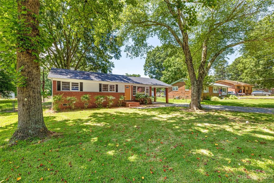 Welcome Home! Under $300,000 brick ranch in Mooresville? Yes it is! New vinyl plank floors in the kitchen and full bath. Original hardwoods throughout the rest of the home. 1 car covered carport and outside storage as well as laundry.
Kitchen has window overlooking spacious flat fenced backyard & painted white cabinets and open to dining/breakfast area. Large enough to add an island. Beautiful picture window in living room. all 3 bedrooms have hardwoods and 1 full bath. Linen closet too. New HVAC & thermostat. Very convenient to everything you need from groceries to restaurants and I-77 is only minutes away. 
Thank you for showing!