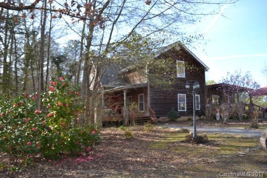 This is a very unique home with cedar and stone exterior. Most living on main level with master and guest bedroom, great room with fireplace/gas logs.  Large kitchen with stainless appliances and a work island.  There is a bonus room upstairs along with another bedroom and awesome bath that could be used as the master suite!  Sits on 6 acres and also has a shop with power, water and a full bath. Carport covering and chandelier in dining room will not convey with home.