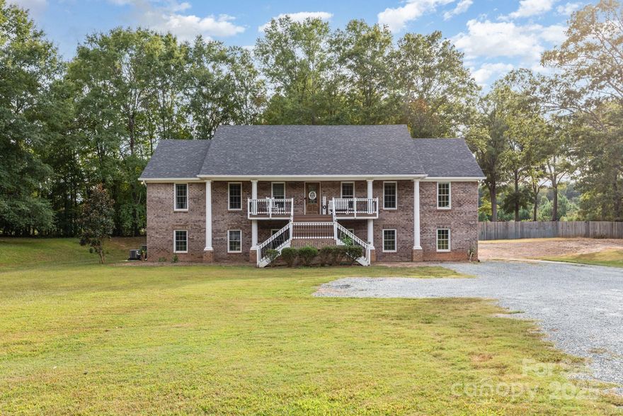 Sellers will agree to a $20,000 Buyer credit for Landscaping, Paint and Carpet with Acceptable offer. Welcome to this beautiful 3-level home perfectly designed for multi-generational living. Boasting two full kitchens, spacious living areas, and a primary suite on the main level, it offers both comfort and convenience. Recent updates bring peace of mind, including a new roof (Summer 2024) and upstairs HVAC system (2024). The home is elevator shaft–ready, allowing for easy future installation if desired. Step outside to a covered patio overlooking approximately 2.3 acres of serene land, perfect for relaxation or entertaining. This property combines the feel of a private retreat with the convenience of being close to shopping, dining, and major roadways—a truly rare find. Schedule a tour today!