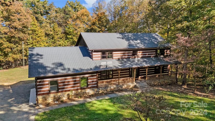 Back on the Market (no fault of home or sellers). Now offered with 14.4 Acres instead of 10! Nicely Updated 4 BR - 3 Bath Log Home in NC Foothills. Very private getaway. Freshly painted inside and out; New gutters, soffit & fascia. Remodeled kitchen w/new appliances and quartz counters with island; New LED lighting throughout; All new faucets and updated vanities; 1 Year Home Warranty;  2 covered decks facing back of home and pool area.  Would make a wonderful VRBO or AIRBNB rental. Only 10 minutes from Stone Mtn State Park and 20 minutes to Blue Ridge Parkway. Very close to all Wineries and Elkin trails, shopping & restaurants. $15K allowance will be provided for pool upgrade or other usage reconfiguration if full offer is submitted. Area would be ideal for Pickleball/Basketball Court. Partial Owner financing available.