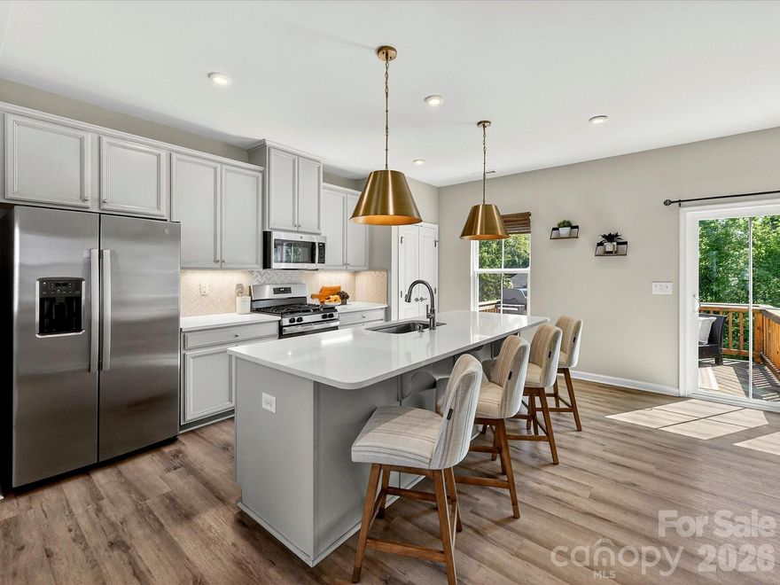 Exciting townhome in popular Grantham Place neighborhood! Excellent location so close to parks, greenways, and the conveniences of Pineville, Ballantyne, South Charlotte, and of course- thriving Fort Mill! Top Rated Fort Mill Schools! Charming, modern, and move-in ready, this impeccably maintained townhome in the desirable Regent Park area offers the perfect blend of comfort, style, and convenience. Step inside to a bright, open-concept home with 9 ft. ceilings, durable LVP flooring, and a stylish kitchen featuring quartz countertops, stainless steel appliances, pendant lighting, and glass tile backsplash. The spacious living and dining areas are ideal for entertaining. And the lovely lofted deck allows for grilling or relaxing in our gorgeous Carolina weather! Upstairs, all three bedrooms are thoughtfully arranged for privacy. The spacious primary suite features a custom closet system and spa-inspired en-suite with a dual-sink vanity and a tiled shower surround. Two generous guest bedrooms are located on the opposite wing. A full-size laundry room on this level adds everyday convenience. The ground level offers a fantastic flex space! Ideal for a home office, gym, media room, or an additional living area. An attached 2 car garage with an extended driveway provides ample parking (so hard to find!). Bonus features are oak stair treads, a gas range, a fully fenced yard, and en trend lighting throughout! Light, bright, and beautiful, this low-maintenance home is the ideal lock and leave opportunity in one of Fort Mill’s most desirable communities.