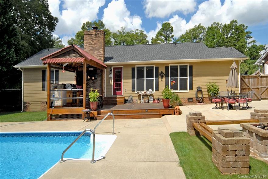 This meticulously well maintained home makes you feel like you are on a permanent vacation! 3 bedrooms 2 baths located in the main home, crown moulding throughout. Great room offers beautiful hardwood floors, raised ceilings, fireplace and large windows with a view of private fenced in backyard with in-ground pool. Backyard also features an outdoor kitchen with bar, patio and fire pit! Separate living quarters in the guest house, w/ kitchen, full bath and a sauna! Perfect home for entertaining!