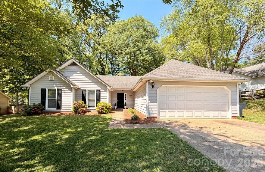 Welcome to this charming 3-bedroom, 2-bath ranch in the desirable Northwoods community, where comfort meets convenience. Nestled on a private, wooded lot with mature trees, this home offers a peaceful retreat just minutes from everything. Inside, a bright open floor plan features vaulted ceilings, LVP throughout, abundant natural light, and a cozy fireplace. The kitchen is well-appointed with newer stainless steel appliances, ample cabinetry, and granite countertops. The spacious primary suite boasts vaulted ceilings, dual vanities, a soaking tub, separate shower, and French doors leading to the backyard. Two additional bedrooms provide flexibility for guests or a home office. Recent HVAC replacement (2024) adds peace of mind. Neighborhood has walking trails, pool and clubhouse, which is optional to join at $270/year. Enjoy easy access to the U.S. National Whitewater Center, Mountain Island Lake, I-485, shopping, and dining. Move-in ready with the perfect blend of privacy and location.