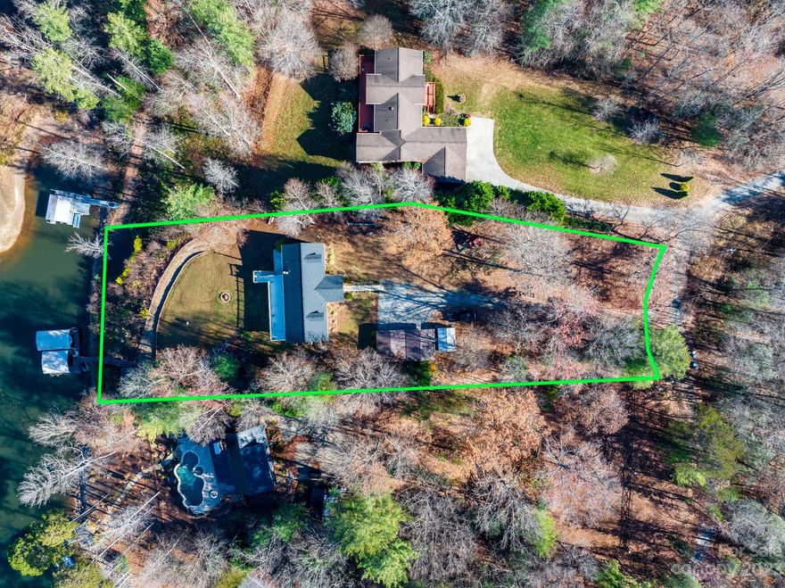 Astounding views of Lake Hickory in this 3400+ square foot home on just over an acre with water frontage.  Upon entry of this home, you notice the views, the living room has a wood burning fireplace, wood floors & vaulted ceiling.  The kitchen features an island w/ range and hood vent along with dining area. The master bedroom is located on main with a WIC & excellent view of the lake.  The master bath has dbl vanity sinks w/ granite countertops and a separate tile shower & tub.  On a split BR plan, bedrooms 2 & 3 are opposite to the master and share a full hall bath.  Laundry room located on main.  The basement features another 3 bedrooms (Septic Permitted for 3) & 3rd full bathroom.  The open basement area offers a 2nd living room area or rec. room and features an updated tile floor. This lake retreat has 2 covered boat slips. Come on home to Lake Hickory in beautiful Alexander County!