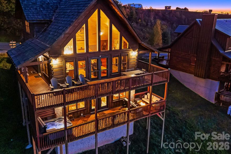 Finally! A turnkey, chalet log cabin with SPECTACULAR long range mountain views! This home offers 3 levels of mountain luxury with multiple oversized windows and expansive decks overlooking the NW facing layered views of the Blue Ridge mountains. This home sleeps 10 people and has 4 bedrooms (though a 3 bedroom septic permit), and 3.5 bathrooms, making it the perfect place to host many large gatherings and holidays. The main level offers an open floor plan, primary bedroom & laundry, stone fireplace, and floor to ceiling windows. On the lower level, you'll find another stone fireplace, the 2nd primary suite, a 2nd living room, and a billiards room! Upstairs features sweeping views, 2 additional bedrooms and a full bathroom. Located next to Hatley Pointe Ski Area, and nearby Bailey Mountain Bike Park, Wolf Ridge Ski Resort, ziplining, white water rafting, and the endless trail systems in Pisgah National Forest, there is no shortage of adventure for you or your guests. A proven successful short term rental, this home grossed about 80K w/ ~68% occupancy in 2025 and comes fully furnished, including a new hot tub! This home has been meticulously maintained with a new heat/air system, and upgrades to the decks. Mars Hill offers a quaint historic Main street, while being conveniently located to Asheville (40 minutes), and Tennessee. Weather you're seeking a lucrative turnkey investment, a tranquil vacation home, or even a year-around oasis, this home is for you.  Grab your favorite agent and check it out today!

AirBnB links: https://www.airbnb.com/rooms/966890963851319484?unique_share_id=9d5c0424-9f6d-43ec-a7bf-3e3090b93193&viralityEntryPoint=1&s=76&source_impression_id=p3_1776789488_P3UfB6vvdvVCMig3