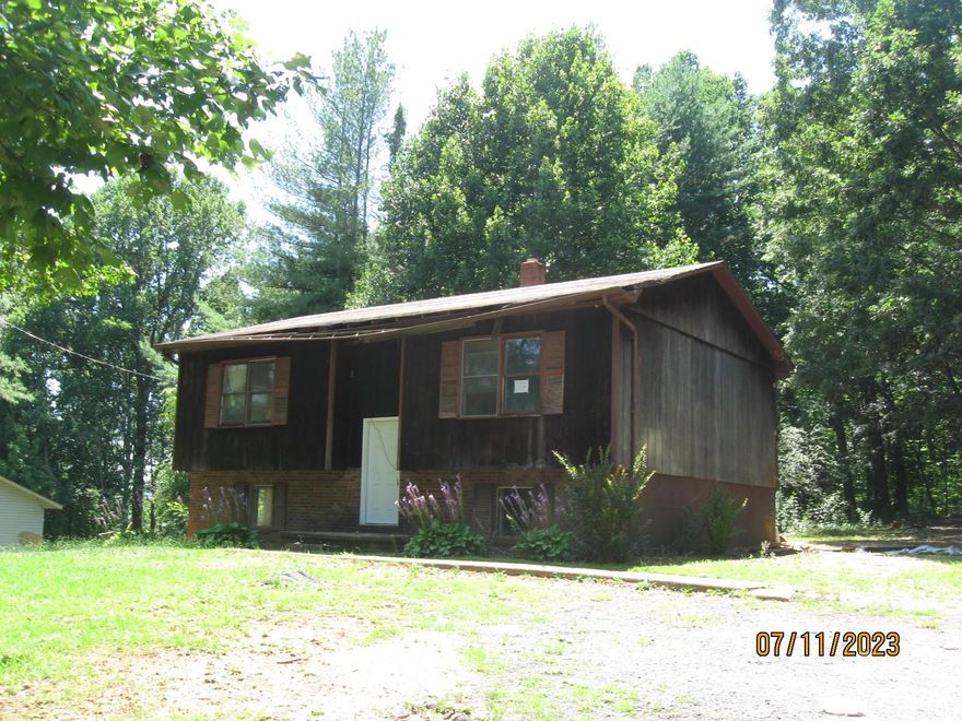 Bring your toolbox. This split-level home is in need of complete renovation. Upgrades needed are including and not limited to new siding, gutter work, back stairs needed to back door, some new sheet rock work, fresh paint, new windows, new flooring, new kitchen, new bathrooms and new heat and air system. Will make nice like new home once updated. Neighbor says it has well and septic. No county water at street. No heat system. Will not qualify for loan unless it is a rehab loan. May be converted to 4-bedroom 2 bath once lower level finished. The style of home is split foyer and has living area upstairs and downstairs. The heat system is not intact so there is no heated area at all until fixed. The area downstairs seems to have been used as living area for two bedrooms and there is a bathroom added downstairs. Not sure if the heat was going to downstairs area or not but probably was. Buyer and buyer agent should confirm before making offer.