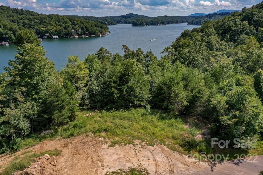 LAKE LURE LAKEFRONT LOT with BIG VIEWS and excellent location. Lot 22 Blue Heron Point has community water,  city sewer and offers a great building site. A Must See at only $335,000!