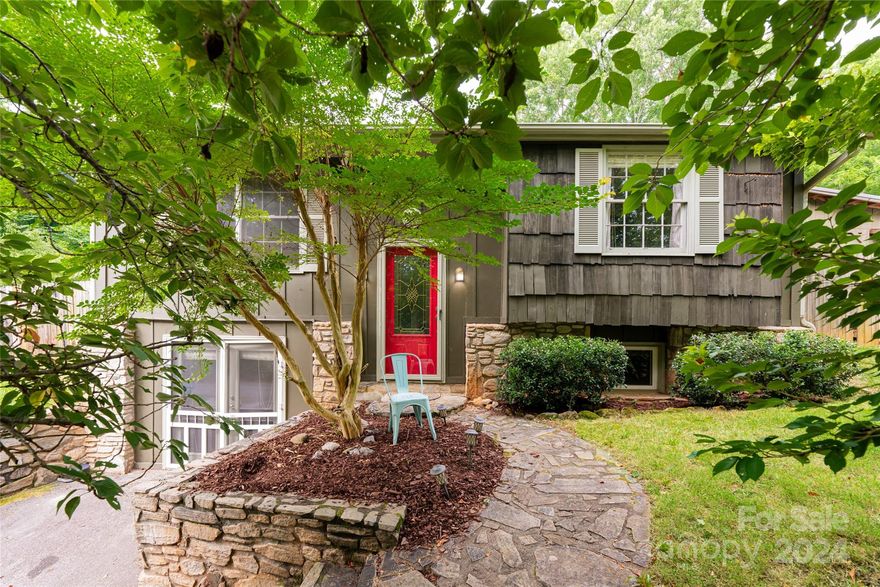 Nestled in the mountains of Candler we find a charming, well-maintained home that has been lovingly cared for. Country mountain living with outdoor spaces tastefully landscaped with mature ornamental trees such as the gorgeous cherry that washes the front in mystical flowers every spring. Spacious primary suite on the main with w/d in the ensuite bath. Downstairs, the versatile and cozy den with walkout access can serve as a game room, or home office, to accommodate family or visiting guests. The private, fenced-in backyard is ideal for grilling and enjoying summer nights. Perfect spot for a garden in the sun and mountain views from the firepit. Idyllic surroundings, an outdoor enthusiast’s dream. Enjoy watching the Asheville Hot Air Balloons land in the open fields at your neighbor’s home across the street. Multiple outbuildings for a workshop and tool storage. No found restrictions. Close and convenient to both Asheville and Waynesville. Come and see what this property has to offer!