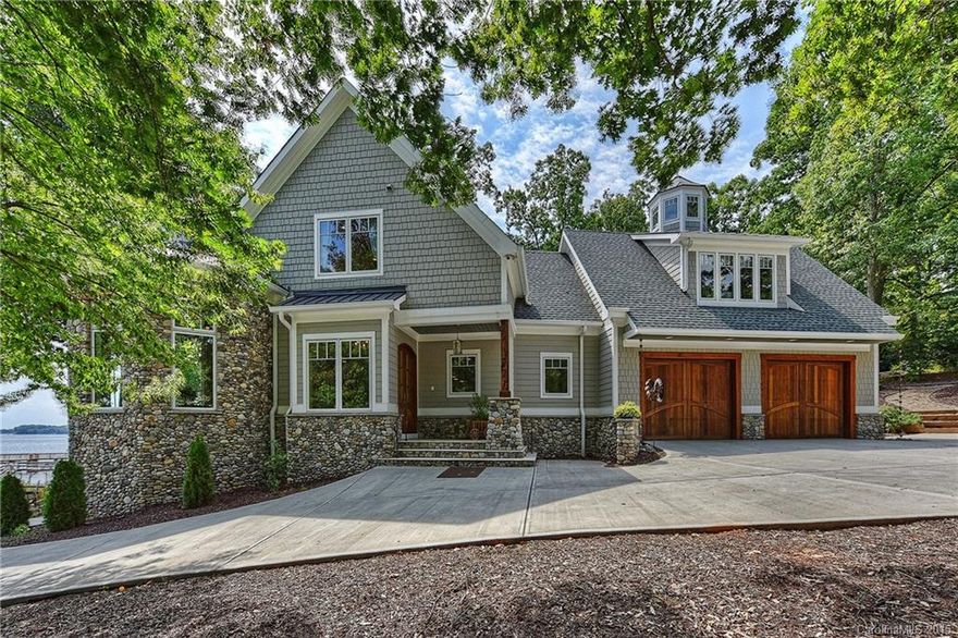 CUSTOM CAPE COD WATERFRONT HOME-almost brand new!Very unique, gorgeous large lot, unbelievable deep views of Lake Norman!Detached guest house for friends/family gatherings(over 5,500 total sq.ft.) Natural sandy beach.Huge covered porch w/ Brazillian Hardwoods.Open floor plan designed for lake views. Beautiful river rock stone gives such an authentic feel to this home.Custom granite&hammered copper farm sink. Wood ceiling in DR,cedar mantle,wood beams, 3 laundry,hidden TV MBath,space for elevator
