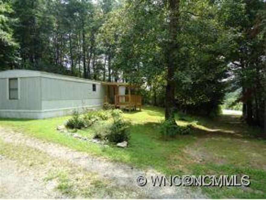 Singlewide with nice front porch, storage building, located on quiet setting in Balsam Grove, this home is currently rented and can remain rented for long term if new owner wishes. Home has room to park a motorcoach or camper on property.  Home can be year round or seasonal.-