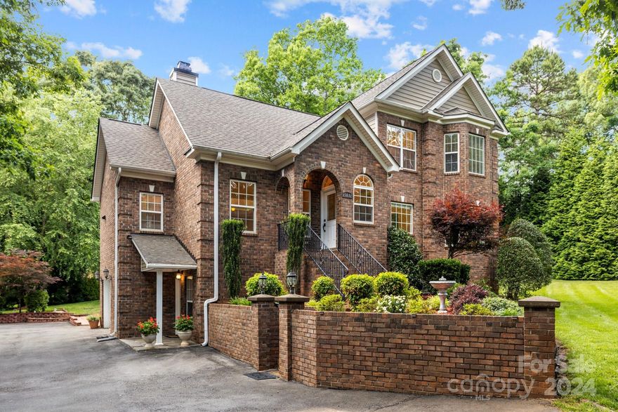 Be King of the Castle in this magnificent custom-built all brick home! Situated on a large lot, the lush yard is adorned with gorgeously manicured landscaping. Soak in the beauty and sounds of nature in the privacy created by the perimeter of mature trees. Cute covered front porch entry. Inside the soaring ceilings in the great room are anchored by a cozy wood-burning fireplace, providing an open and airy feel. 9' ceilings throughout. Excellent floorpan, great layout and flow. Spacious kitchen with plentiful cabinet and countertop space. Primary suite on main with sizable master-bath. Bedrooms have walk-in closets. Additional bonus room upstairs can be 5th bedroom, with loft space for lounge/office. Fully rentable downstairs bedroom and bathroom (with separate entrance) to help with cashflow! Amazing storage space in basement. Enjoy the fairy-book paradise outside on the multi-level deck. Functional wired shed, storage shed, and carport. Great location and no HOA! Showings start 5/21.