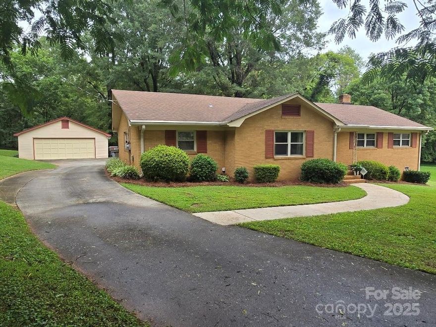 Spacious, all brick home, located in the back of a quiet neighborhood in cul-de-sac. Large backyard with woods behind for privacy. Easy access to shopping, banks and restaurants. 15 minutes from uptown Charlotte and 10 minutes from 485. One owner, well maintained home. French doors from the dining room to screened in porch with views of the backyard and woods. Original bathrooms with tile flooring, bedrooms/living room carpet, multiple ceiling fans throughout the home. Kitchen/hall has nice well kept vinyl. Large laundry room with shelves for storage. Enjoy bonus room for family activities with windows for bright light and built in bookshelves, or space in laundry rm to make closet for the bonus rm to make 4th bedroom. New kitchen faucet, Corian type countertops, all kitchen appliances less than 3 years old. New 2025 HVAC. Detached double garage is insulated with window unit, ceiling fan and 220 electrical for work shop and/or electric vehicle. Outside the garage is a place to park extra vehicle and hook-ups for electric and water (RV). NO HOA! Schedule to see this well cared for home. Make a few updates with your own likes and colors.