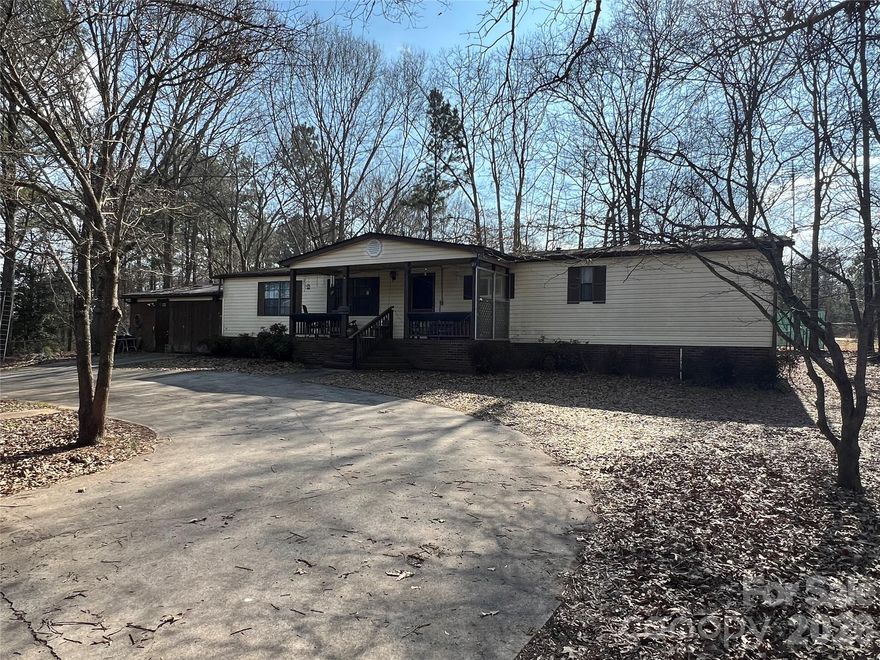 Motivated Seller says bring offers! Comfort, space and lots of storage is what you get with this 3 bedroom 2 bath home. Home has an open floor plan and split bedroom plan. You will find plenty of storage inside and out of the home. Kitchen has a great pantry. Flooring consists of vinyl plank, carpet in 2 bedrooms and new engineered wood in kitchen as well as new kitchen counters. New stainless steel refrigerator is negotiable. The outside space makes it easy to expand on this level .98 acre that is mostly fenced. Concrete solid front covered porch and back porch with brick underpinning and a concrete driveway add to the solid state of this home and property. Home has mini splits for air and heat that were installed in 2021. Master bedroom has a large walkin closet as well as a large wallkin shower that has new shower tiles and his and her sinks. 3 large bonus closets in master bathroom. The laundry room has plenty of storage and a utility sink. Attached carport was converted into an enclosed 1 car garage with electric operating doors and a workshop with electric and lights. There is also a storage building outside for even more storage space. The outdoor fireplace in back yard is perfect for entertaining or relaxing and there is a beautiful water fountain in front of home with lights that you can see from just about anywhere on the property. You will be surprised to see all this one has to offer!  Sold As Is