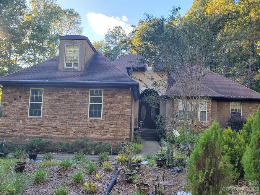 Gorgeous full brick with stone ranch-style home, a three car garage, and a beautiful garden in the front. The house itself offers an open floor plan, with very high ceilings, a large wood burning fireplace, a kitchen with breakfast area and bay windows and a island, with granite countertops and backsplash. There is no pantry but it has a nice sunroom with tile floors and an extra large laundry room that can be used as a storage. Four bedrooms and four full bath, a large bonus room over the garage with full bath. Master bedroom is very seclusive with his and hers closets and a large bath which includes a shower  bath tub and two separate sink units. The house has two water filtration system, one for the whole house and one for drinking water. The seller in the process of packing their stuff.