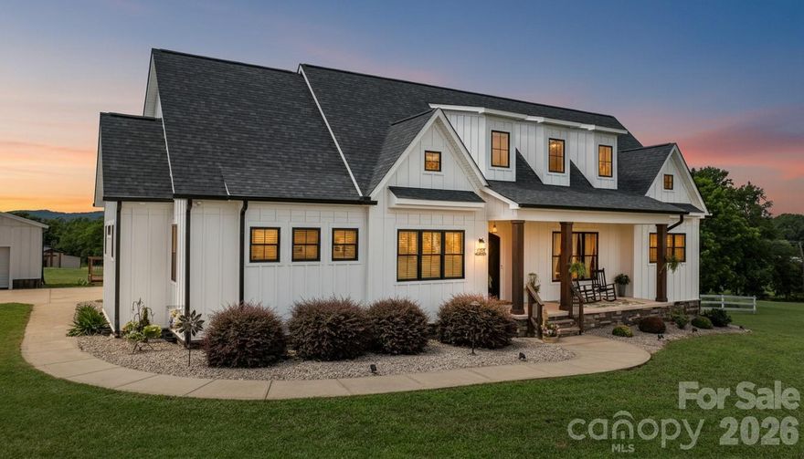 Dreaming of building your own modern farmhouse with acreage, mountain views and endless possibilities?  Look no further, someone else has done the designing and building for you!  Better than new, this custom-built stunning modern farmhouse was built in 2020 and sits on nearly 19 acres of peaceful countryside with a natural spring and a walking trail on the property ready for you to explore.  Ten of these acres are already fenced in so bring your animals.  This property offers the privacy, space, and serenity of rural living while still being just minutes from town. It’s the rare property that gives you the best of both worlds: a true country setting with easy access to Hickory’s shopping, dining, schools, and conveniences.

The home’s warm, modern aesthetic is elevated even further with a rocking chair front porch and stunning iron front doors that make a bold, welcoming statement.  Once inside, this thoughtfully designed home blends clean modern design with classic farmhouse warmth. Sun-filled living spaces, quality craftsmanship, and an inviting open layout make it ideal for both everyday comfort and effortless entertaining.  

Many upgrades in this design, including marble countertops in kitchen and baths, state of the art "smart" appliances, custom cabinetry, hand scraped wood floors throughout, 10 ft. ceilings and 8 ft. doors.  The kitchen is a chef's dream, and you will love the extra thought and expense given to creating a space you will enjoy cooking & entertaining in for years to come. As a bonus to this beautiful kitchen, there is a large cafe style window that opens up to your spacious covered back porch. This space will be one of your favorite spots for morning coffee, relaxing with family and friends, taking in the views and watching those gorgeous sunsets.  The inviting family room is comfortable, spacious and features built-ins, fireplace and is open to the formal dining area with plenty of room for a large table to seat all of your guests Next, prepare to be wowed by the spacious primary bedroom features a gorgeous primary bath with tile floors, tile shower, double vanities with marble counters, "smart" mirrors, soaking tub and a walk-in closet sure to please the pickiest buyers! There are 3 additional bedrooms on the main level, one of those bedrooms is currently being utilized as a home office.  Another full bath and a powder room with beautiful finishes complete the baths on the first floor.  You also have main floor laundry/mudroom with storage and organization built in.  Every convenience is on one level, but these sellers have thought of everything in this design and even included a bonus space upstairs that has a separate entrance.  This is currently set up as a 5th bedroom and it has its own kitchenette and full bath, perfect for guests, mother-n-law suite or even has the potential to be a rental opportunity!  For parking you have an attached oversized double garage and a separate 24x24 double garage/workshop.

Once outside and the land opens up around you—rolling acreage, room to explore, and endless possibilities for recreation, hobbies, or expansion.  A major highlight of the property is the brand-new barn completed in 2025. Designed with versatility in mind, it’s already set up to function as a venue—perfect for weddings, events, workshops, or gatherings. But its potential doesn’t stop there. Whether you envision an equestrian facility, a creative studio, a hobby barn, or an income-producing venture, this space is ready to bring your ideas to life. It has ample space, 3 half baths, a full kitchen and boasts 2,343 square feet.  

With its modern farmhouse charm, expansive acreage, barn/venue opportunity and unbeatable Hickory location, this property offers a rare & unique opportunity to create the lifestyle you’ve been dreaming of.  Book your showing today!