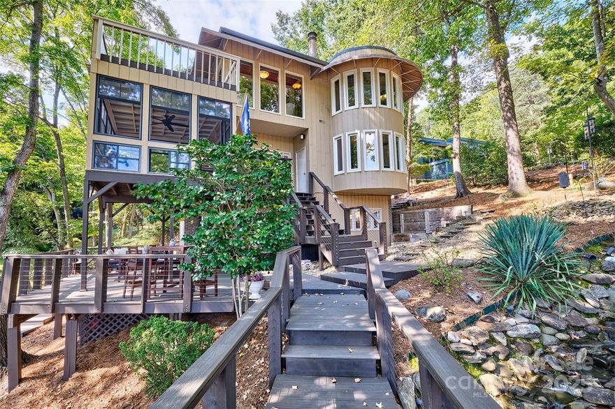 Welcome home to this amazing waterfront home nestled in the heart of Lake Wylie and River Hills neighborhood.  Located in a quiet cove right off the main channel so easy access to anywhere on the lake you want to go.  This home offers 4 bedrooms, 2 1/12 baths and so many outdoor living spaces to enjoy!  Enjoy the babbling brook, the 4 season porch that feels like a tree house overlooking the water, 3 levels of decks - all done with trex decking - covered huge deck for outdoor dining, the dock with lift is even trex for maintenance free.  Primary bedroom , luxurious bath and sitting room are on the top floor for dramatic views ! Main level offers 2 story great room with stacked stone fireplace and lots of windows, kitchen, dining room and seating area.  The lower level offers 3 bedrooms, bathroom , laundry and access to outside for separate entrance.  Could be multi generational living. The home has been meticulously maintained .  The lake is calling! Come enjoy the views!