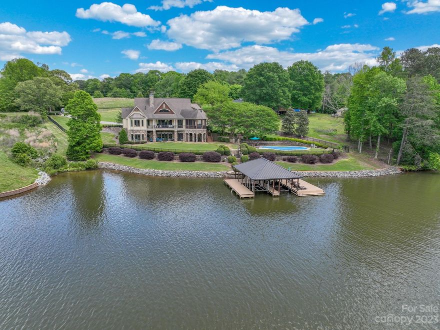 Gorgeous Craftsman style lakefront home in idyllic setting.  This is the best home on Moss Lake!  Beautiful landscaping on over l acre, gated main entrance, fully fenced, in-ground pool, and private boat dock with lifts for two boats.  Main floor features large great room with vaulted ceiling, gas fireplace, gourmet kitchen with GE Monogram appliances, laundry, dining room, breakfast nook, office or living room, primary bedroom with en-suite bathroom, large covered deck and screened in porch.  Large bonus room over garage features full bathroom and closet.  Basement includes 2nd primary bedroom with en-suite bathroom, 3rd bedroom with full bath, additional room which can be used as a bedroom, large storage area, and theater room.  Home sold fully furnished with all interior and exterior furniture, appliances, decor, TVs, sound system, security system, cameras, Nest thermostats, etc.  Only items not included are personal photographs, small personal items, clothes, and automobiles.