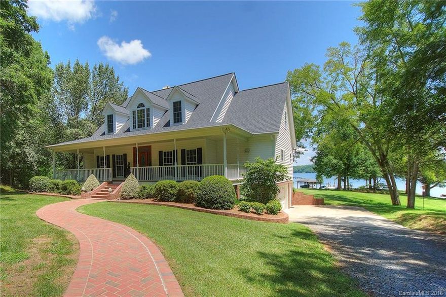 So many things to love about this beautiful waterfront home! Sprawling porches on the front & lakeside, gently sloping yard for easy access to the lake. Deep water dock w/ covered lift, located in an inlet with views of the main channel, yet protected from open water traffic. Eastern exposure for gorgeous sunrise views, refreshing shade in the afternoons. Two story great room. Executive office, plus home office station in the laundry. Lots of updates in kitchen & baths. 2000sqft unf. basement.