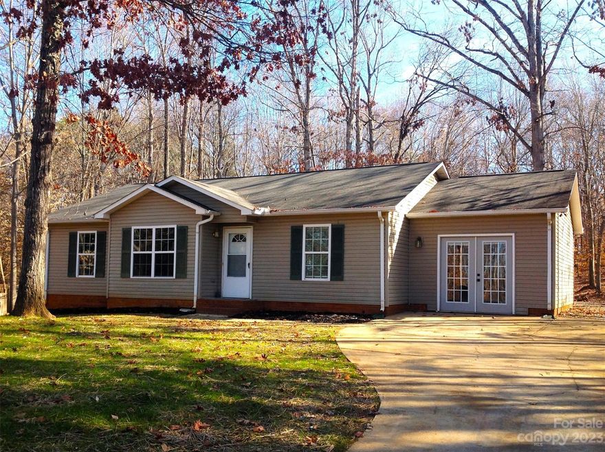 Welcome home to this newly updated ranch, with an open floorplan. Fresh interior paint, LVP & tile throughout & a new wood ceiling beam in the great room. Freshly painted kit cabinets, new quartz countertops & a new sink w/new hardware. The large back room would make a great rec room/bonus room and the converted garage is an ideal playroom or office. Enjoy the covered patio, perfect for cookouts & relaxing. Large wooded yard w/an old shed...perfect for storage,workshop, your car or even a pony! Freshly seeded front yard.