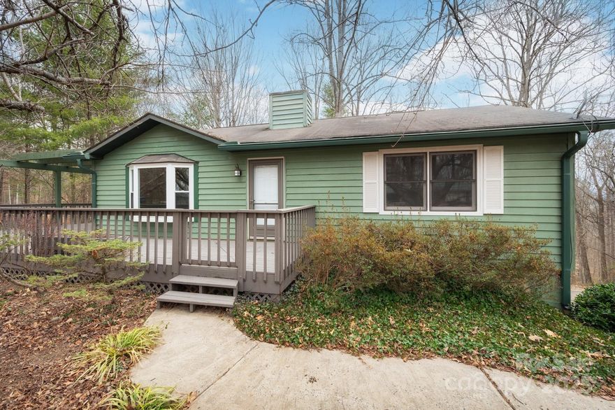 Updated 1980 home with a fully finished basement and expansive outdoor living areas on 1.49 wooded acres with mountain views. Located on a quiet, dead-end street in a peaceful, woodsy neighborhood; only a short drive to Weaverville and downtown Asheville. Three bedrooms, two full bathrooms, a basement bonus room with wet bar, and more than 2,000 SF of heated living space inside; a wraparound deck, upper and lower porches, a shed, and a circular driveway outside. Upgrades include bamboo flooring, gas fireplace, interior paint, recent deck repairs, many replacement windows/doors, and more, including a fully remodeled lower-level bathroom with a walk-in shower. Only small additional repairs and light maintenance are needed to make this property shine. If you’re looking for a fantastic first home, a long-term residence, or an investment property in a tranquil and private setting enveloped by nature, this home is for you. Mature landscaping. NO HOA. Open-use zoning. Same owner since 2006.